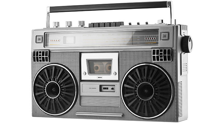 A silver retro boombox with dual speakers and a cassette deck on a white background.